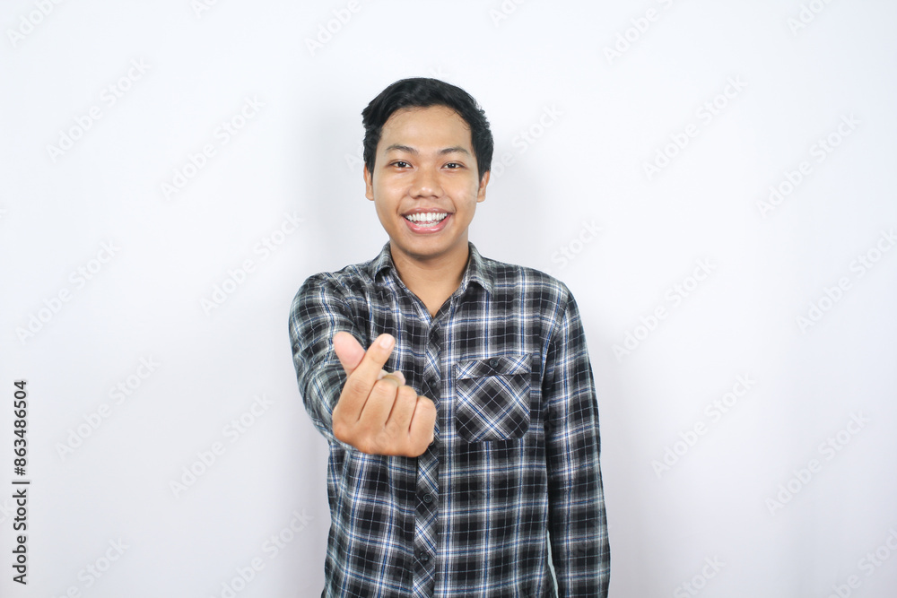 positive asian man showing korean love symbol with happy smile isolated
