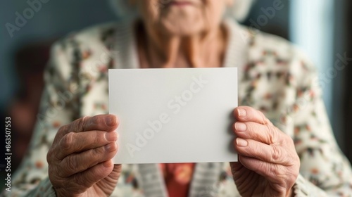 Senior woman holding blank card up close