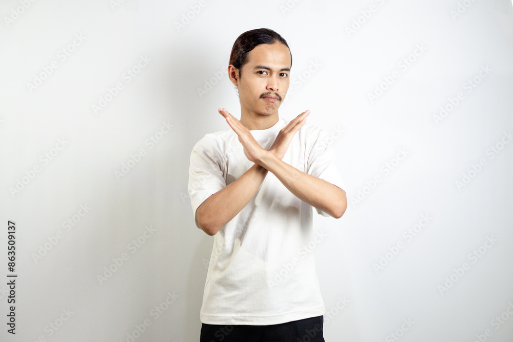 Young man wearing a white t-shirt. make movements not with your hands. crossed arms. There isn't any. sign isolated on white background Young man wearing a white t-shirt. make movements not with your hands. crossed arms. There isn't any. sign isolated on white background