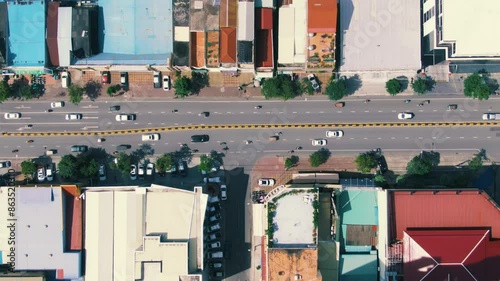 Top-Down Aerial View of Phnom Penh Urban Street with Vehicles and Buildings
