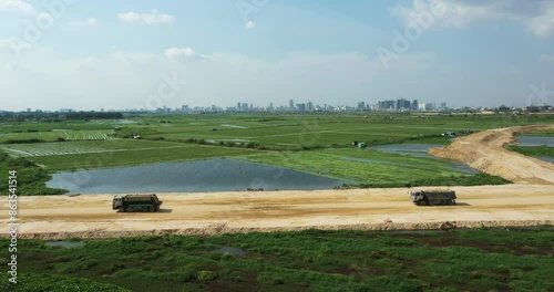 Truck car deliver dirt to fill lack, Aerial view of Development near by cityscape, Phnom Penh Cambodia 