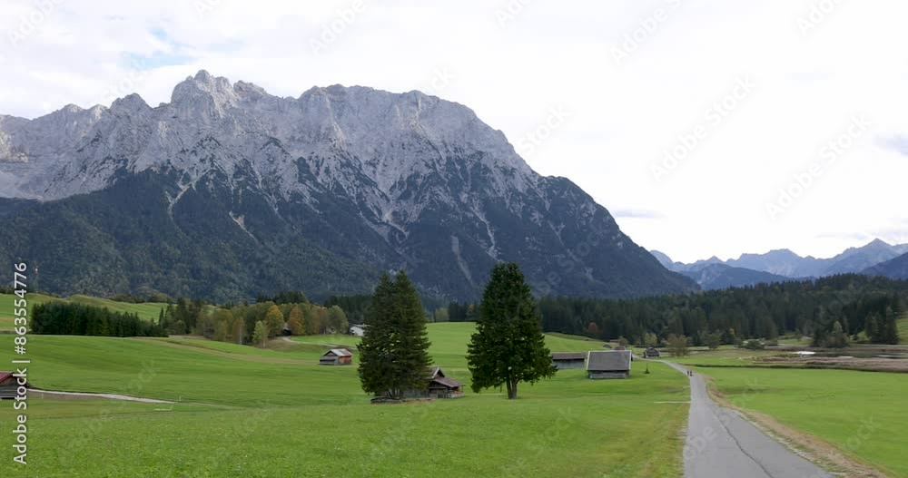 Scenic landscape of fields and mountains at Garmisch-Partenkirchen in Germany Scenic landscape of fields and mountains at Garmisch-Partenkirchen in Germany