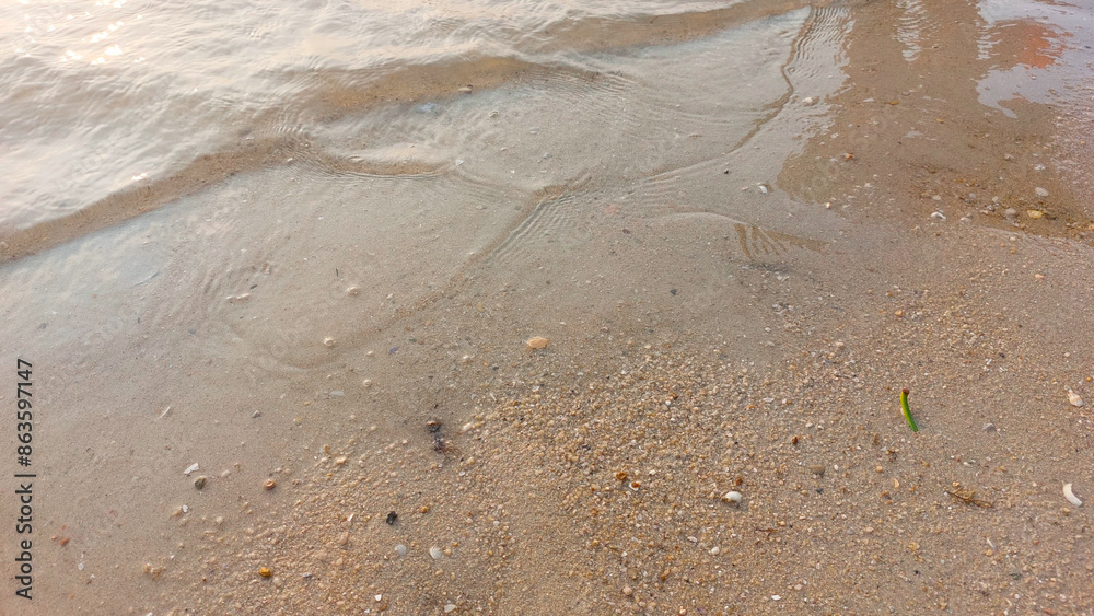 Close up soft wave lapped the sandy beach. natural abstract background and texture Close up soft wave lapped the sandy beach. natural abstract background and texture