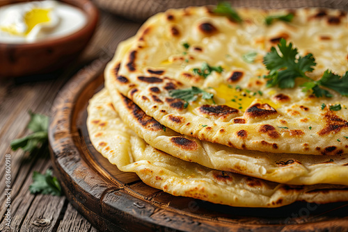 Indian flatbread stuffed with potatoes, aloo paratha, served with butter or curd, traditional cuisine