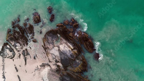 Breathtaking drone footage captures the rugged beauty of a rocky beach and the mesmerizing green ocean. Experience the natural splendor and tranquility of this coastal paradise from above.