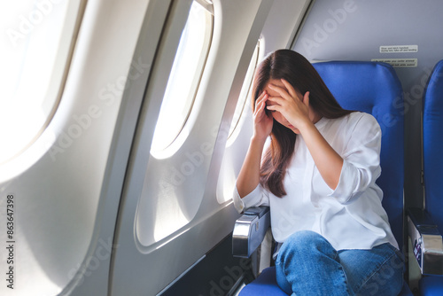Fotografie Portrait image of a woman get airsick and headache while traveling on airplane