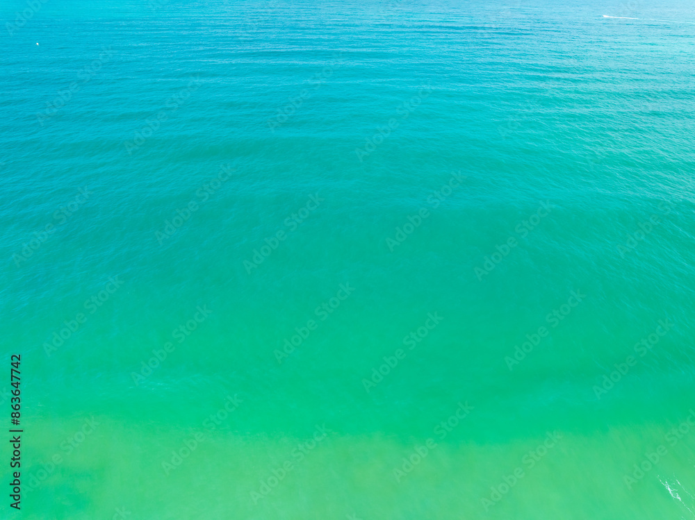 Obraz premium Aerial view of amazing sea surface water texture background,Sun reflections over ocean, Aerial flying drone view Waves water surface texture on sunny tropical ocean in Phuket island Thailand