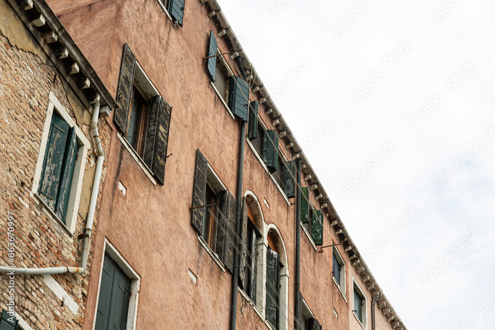 View to typical house in Venice with windows with shutters View to typical house in Venice with windows with shutters