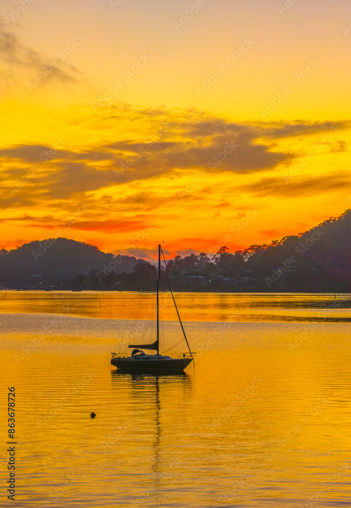 Sunrise over the calm water with boats and reflections Sunrise over the calm water with boats and reflections