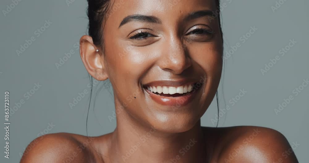 Indian woman, beauty and skincare on studio background with wink and happy face for wellness or confidence. Model, portrait and glow with smile for healthy facial, dermatology and cosmetics or makeup