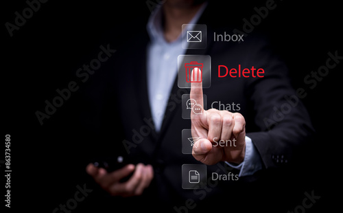 The programmer's hand is tapping on the file icon under the concept of data deletion. The concept  technology and document management.data deletion and removal photo