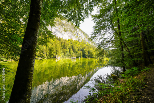 View of the Berglsteiner Lake with the surrounding green nature. Idyllic mountain lake in the Alpbachtal in Tyrol near Kufstein. Landscape in Austria.
 photo