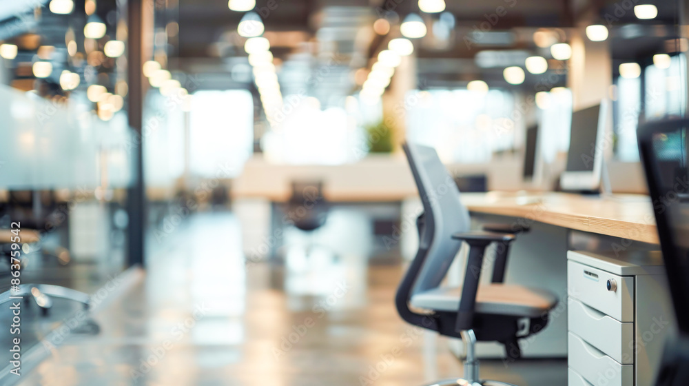 Fototapeta premium A fully blurred background of a modern office space with sleek desks and ergonomic chairs