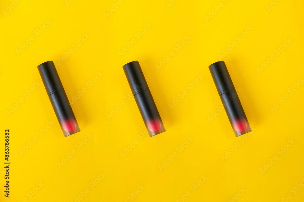 Close up of lip gloss, isolated on yellow background. Close up of lip gloss, isolated on yellow background.