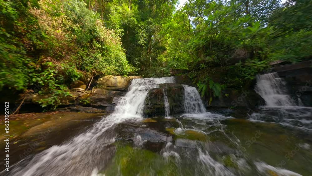 Smooth FPV flight over cascading river and beautiful waterfall in tropical rainforest in Thailand Smooth FPV flight over cascading river and beautiful waterfall in tropical rainforest in Thailand