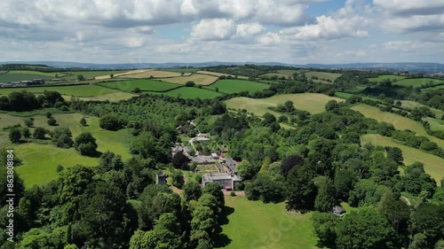 Cockington, Torbay, South Devon, England: DRONE VIEWS: Cockington Court with St George and St Mary Church. Torbay is a popular UK holiday destination with many different tourist attractions (Clip 1). photo