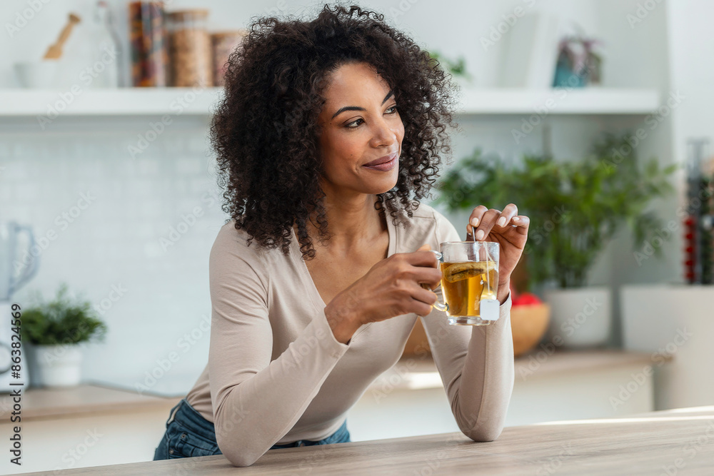 Beautiful woman drinking a tea in the kitchen at home. Beautiful woman drinking a tea in the kitchen at home.
