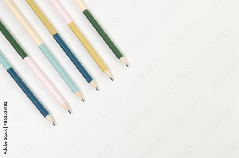 Top view of colorful pencils on white background. School, office, art wallpaper. Flat lay, copy space. Top view of colorful pencils on white background. School, office, art wallpaper. Flat lay, copy space.