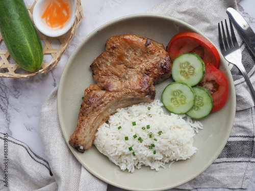 Grilled Pork Chop over rice - Vietnamese food called Suon Nuong at top view  photo