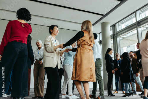 Tableau sur toile Women greeting and mingling at an office event with colleagues