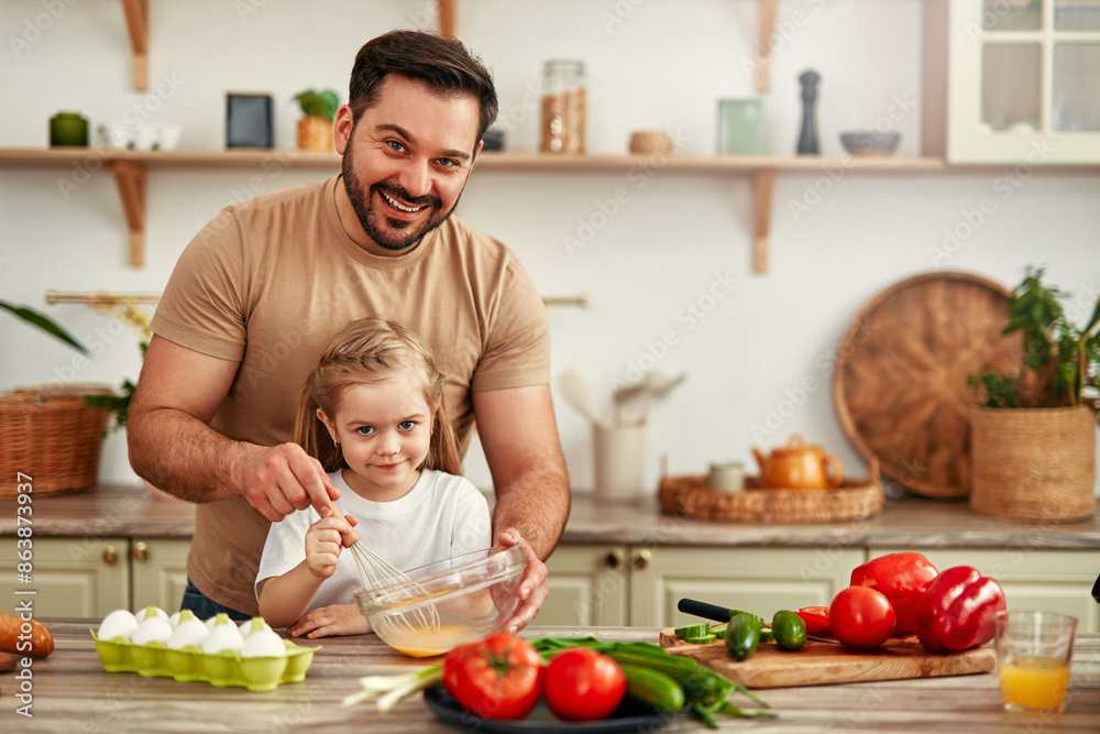 Father and daughter bonding while cooking with fresh ingredients in the kitchen Father and daughter bonding while cooking with fresh ingredients in the kitchen