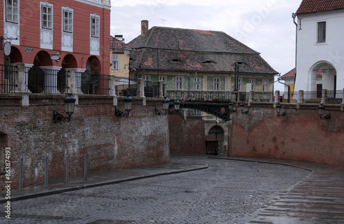 Photo with a view of the Small Square (Piata Mica) and Liars' Bridge (Podul Minciunilor) during the rain in Sibiu, Romania photo