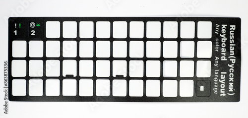 Empty packaging from stickers for laptop keyboard Russian English font, holes from stickers in frame, isolated on white, close-up © catocala