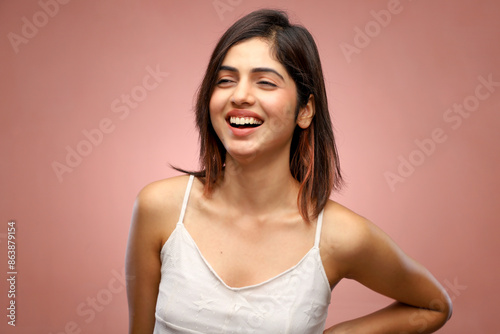 Smiling Woman Standing in Front of Pink Background