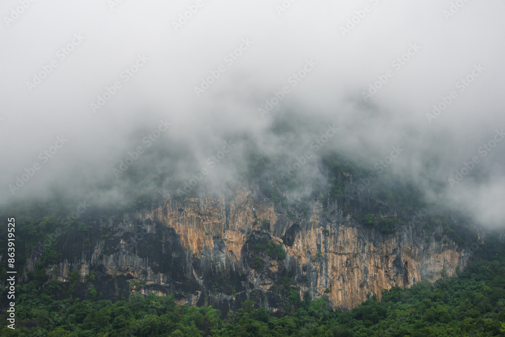 Fototapeta premium Thick fog on dramatic cliffs. Beautiful landscape after the rain