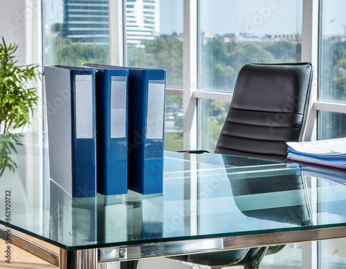 Binders on on glass desk in modern office