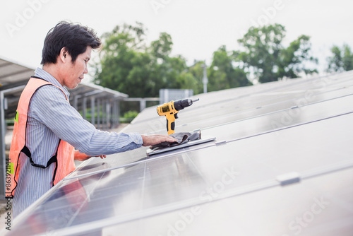 Male electrician installs solar panels solar energy Clean and environmentally friendly alternative energy.