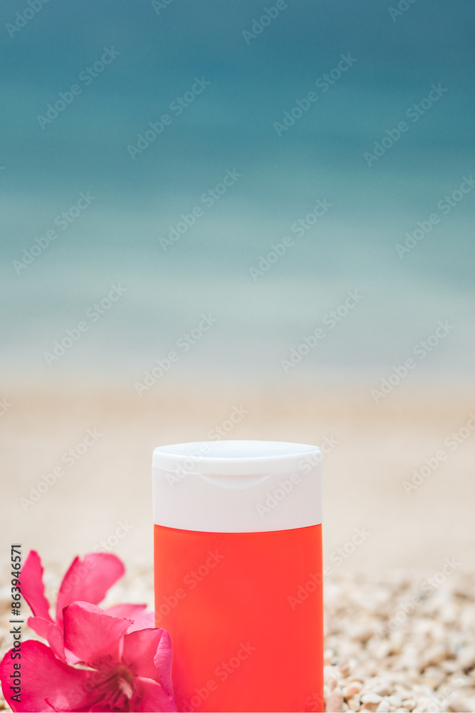 Bright sunscreen bottle on pebble beach with sea as background. Concept of minimalist design of advertisement of sunscreen or cosmetics. Protection against ultraviolet rays or harmful effects of sun Bright sunscreen bottle on pebble beach with sea as background. Concept of minimalist design of advertisement of sunscreen or cosmetics. Protection against ultraviolet rays or harmful effects of sun