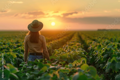 Obraz na płótnie Caucasian female farm worker inspecting soy field in Ukraine. w salonie