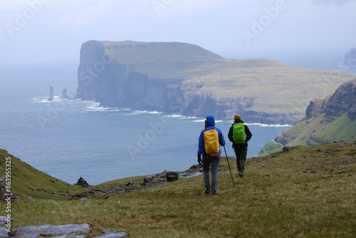 Mountain trip from Saksun village of Saksun to Tjornuvik on island of Streymoy. Silhouettes of hiking people on trail. Faroe Islands, Denmark