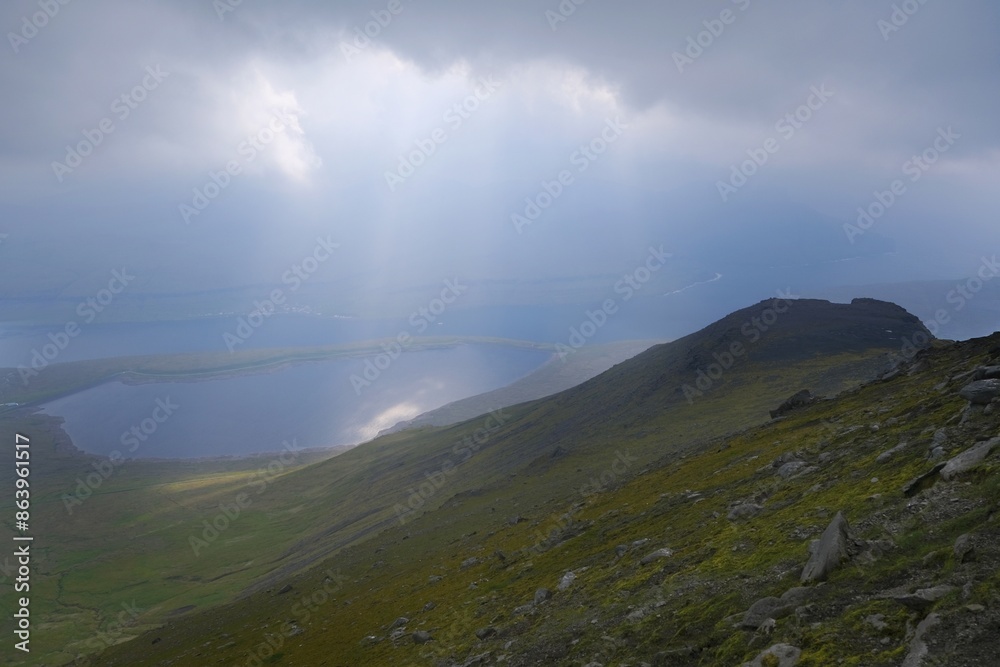 Mountain landscape with foggy scenery - trail to the highest peak of the Faroe Islands - Slættaratindur on Eysturoy Island, Faroe Islands, Denmark. Mountain landscape with foggy scenery - trail to the highest peak of the Faroe Islands - Slættaratindur on Eysturoy Island, Faroe Islands, Denmark.