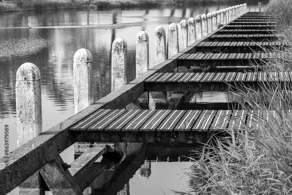 Fototapeta premium Landing stage on a canal, greyscale shot