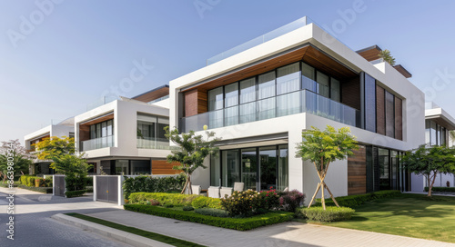 Exterior photo of a modern villa in Dubai on a sunny day, with green lawn and trees around the house.. Created with Ai