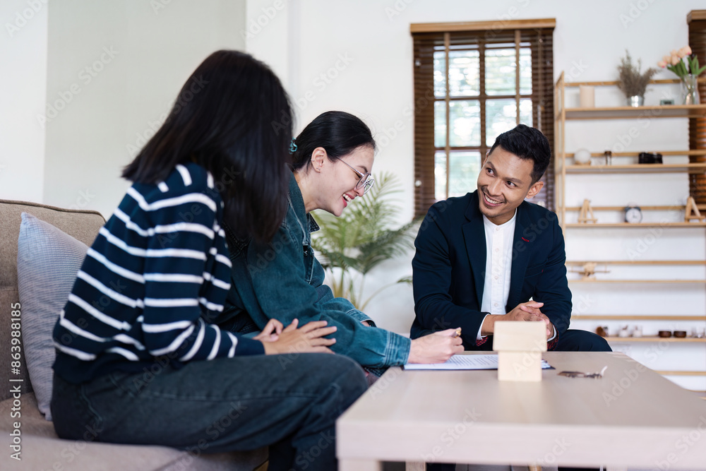 Real Estate Agent Assisting lgbt lesbian Couple client with Signing Contract for New Home Purchase in Modern Living Room Setting Real Estate Agent Assisting lgbt lesbian Couple client with Signing Contract for New Home Purchase in Modern Living Room Setting