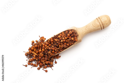 Top view of a wooden scoop filled with Organic Ceylon Ironwood or Nagkesar (Mesua ferrea) seeds. Isolated on a white background. photo