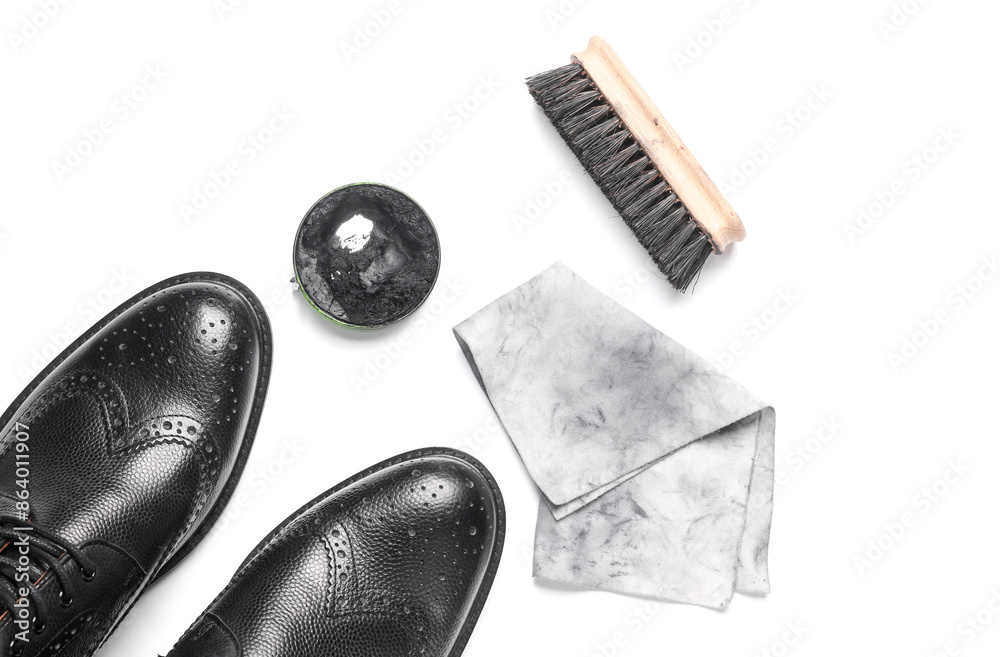 Boots, Shoe polish, rag and brush on a white background. Leather shoe care. Flat lay. Top view Boots, Shoe polish, rag and brush on a white background. Leather shoe care. Flat lay. Top view