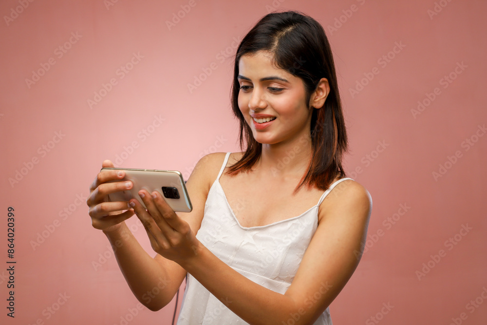 A Woman With Long Hair Standing And Watching Video On Her Phone A Woman With Long Hair Standing And Watching Video On Her Phone