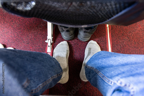 POV of airplane passenger wearing socks only after removing shoes for relaxaton durng long haul flight photo