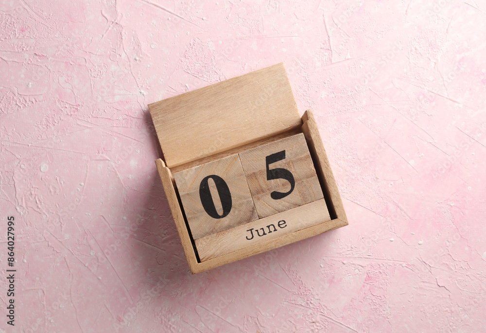 Wooden block calendar with date June 5 on pink concrete background Wooden block calendar with date June 5 on pink concrete background