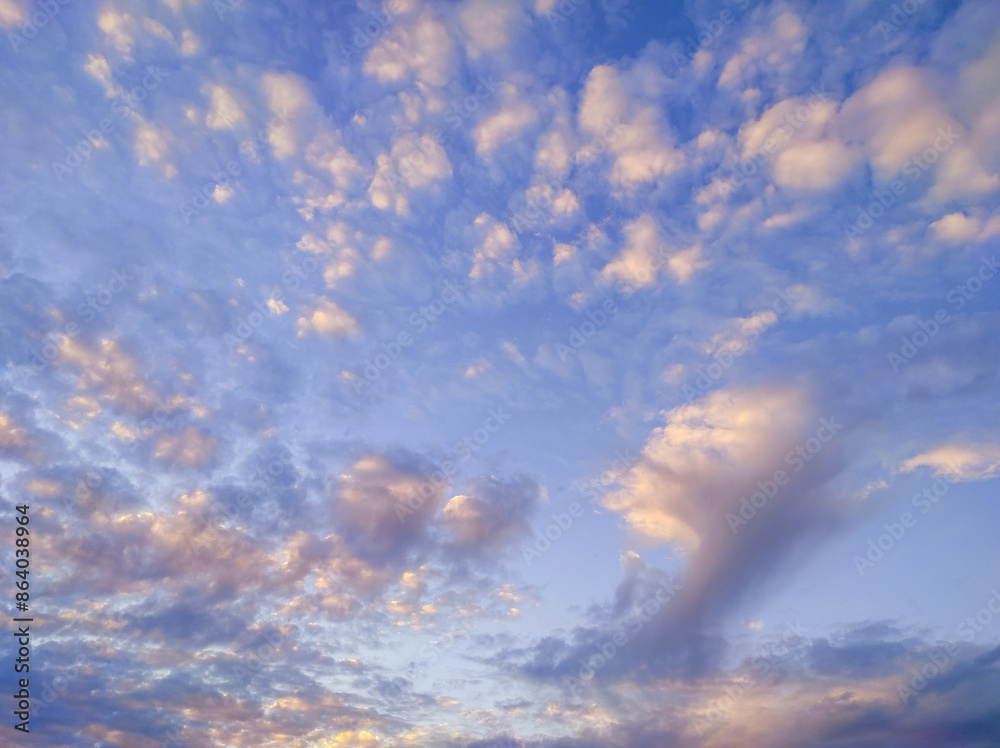 Obraz premium Many colourful clouds in sky, beautiful background. Evening sunset sky with small bright clouds, calm atmosphere
