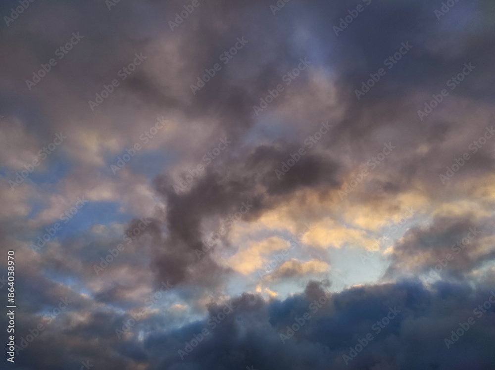 Dark dramatic clouds in sky. Evening photo of dark colorful clouds illuminated by setting sun Dark dramatic clouds in sky. Evening photo of dark colorful clouds illuminated by setting sun