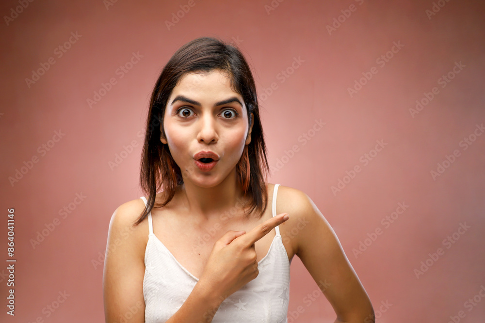 An Excited Woman Pointing Her Finger Towards Her Left An Excited Woman Pointing Her Finger Towards Her Left
