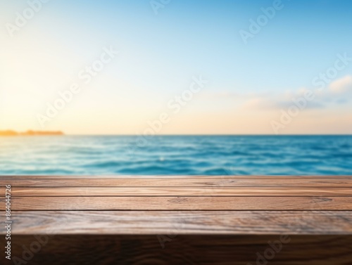 Empty wooden table with a view of the ocean in the background. © whilerests