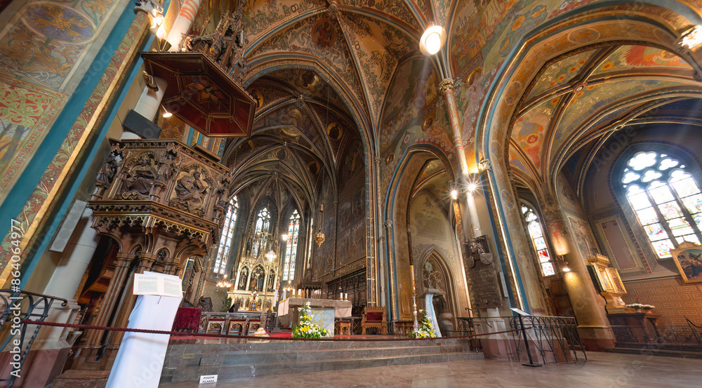 Obraz premium The interior of Basilica of Sts Peter and Paul with frescoes on the walls and ceiling and an ornate wooden pulpit. Prague, Czech Republic