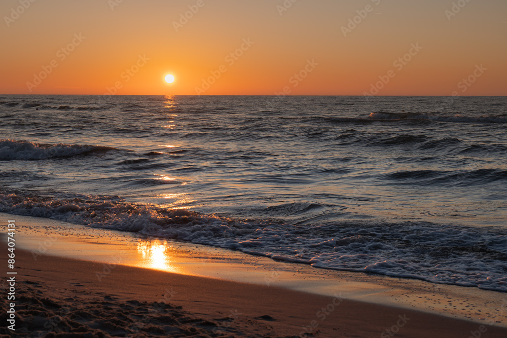 Naklejka premium Beautiful sunset on the beach Baltic Sea, Poland. Piękny zachód słońca Golden Hour.