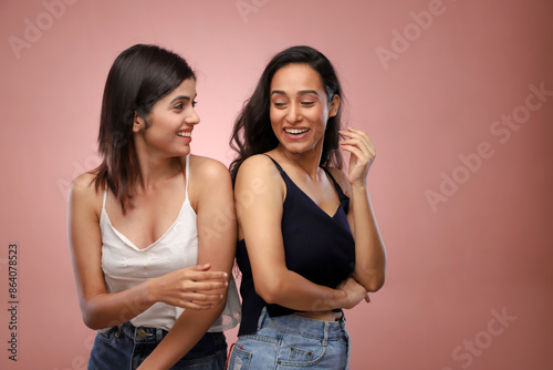 Two Elegant Women Posing In Front Of The Camera.